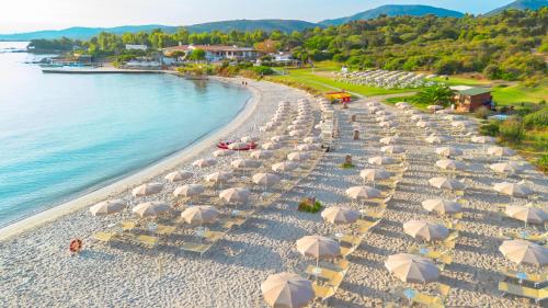 an overhead view of a beach with chairs and umbrellas at AMASEA Resort in San Teodoro