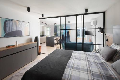 Un dormitorio con una cama grande y una sala de estar. en Apartments Ginger & Blue in a charming historic town, en Labin
