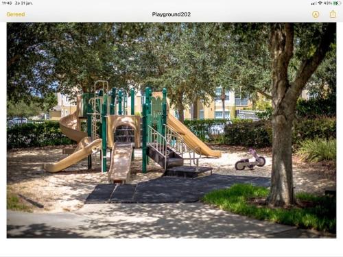 a playground with a slide in a park at Mickey Holiday Home a Windsor Palms Villa in Kissimmee