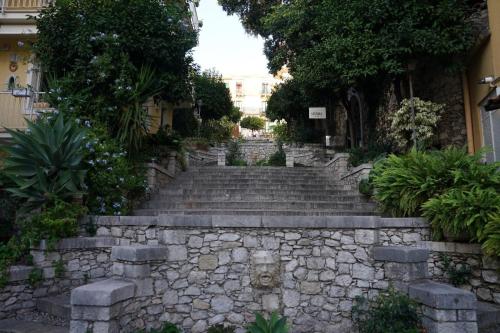 a stone staircase leading up to a building at Opuntia Charming Rooms in Taormina