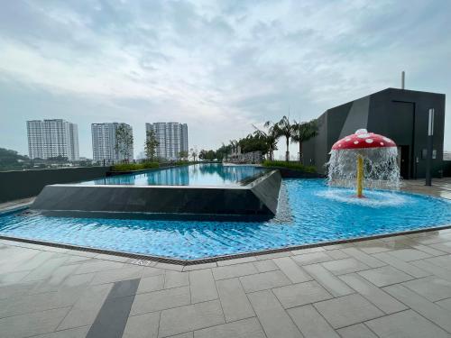 a swimming pool with an umbrella and a fountain at 1 Room Studio @ MKH Boulevard 2 in Kajang