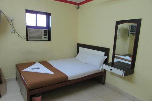 Hotel Grand Skylight tesisinde bir odada yatak veya yataklar