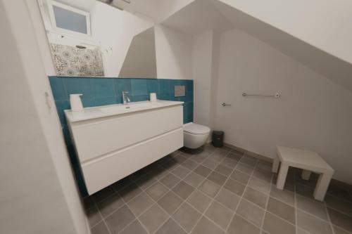 a bathroom with a sink and a toilet at Opuntia Charming Rooms in Taormina