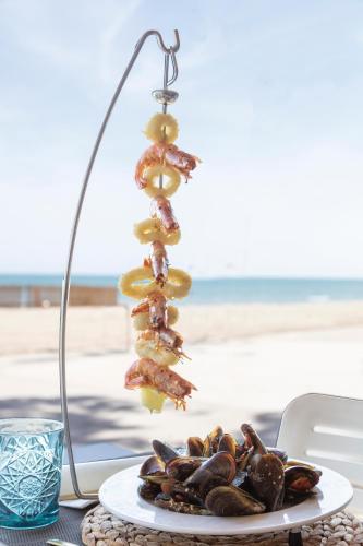 a plate of food on a table next to the beach at Hotel Best Terramarina in La Pineda