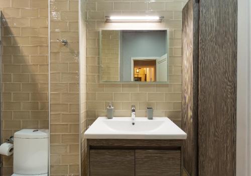 a bathroom with a sink and a mirror at HD Dream Apartment in Tbilisi City