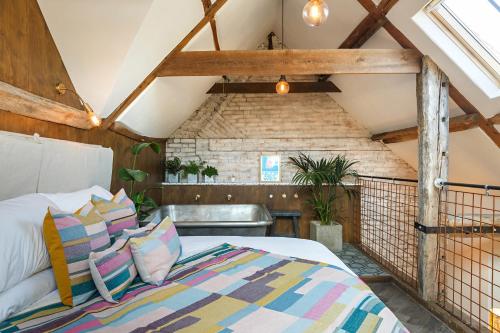 a bedroom with a bed in a attic at Shirehall Apartments in Holt