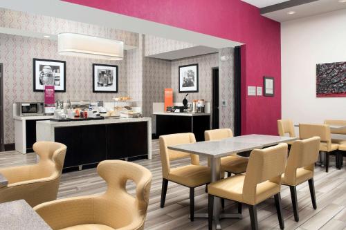 a dining room with a table and chairs at Hampton Inn Huntsville/Village of Providence, AL in Huntsville