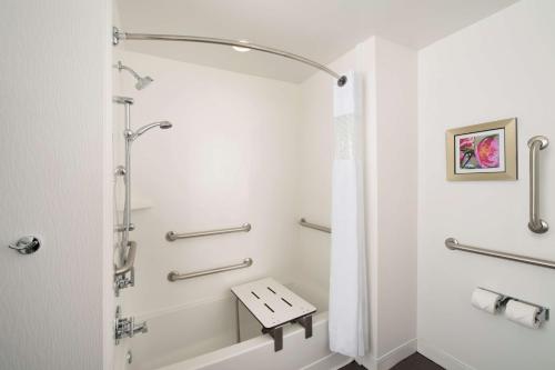 a bathroom with a shower and a bench in it at Hampton Inn Huntsville/Village of Providence, AL in Huntsville