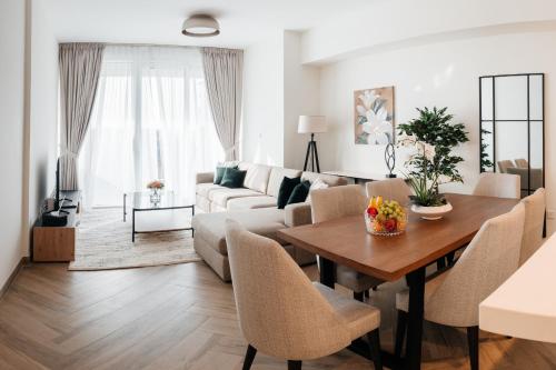 a living room with a table and a couch at 2BR 1 Residences Zabeel with Sleeps 5 - Luxury Stay in Dubai