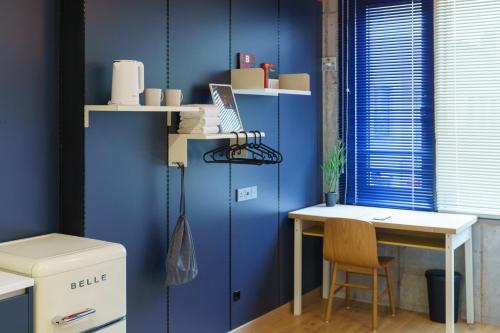 a blue room with a desk and a blue wall at Local Stitch Creator Town Seogyo in Seoul