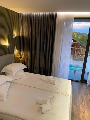 two beds in a hotel room with a large window at Casa Viilor in Chişinău