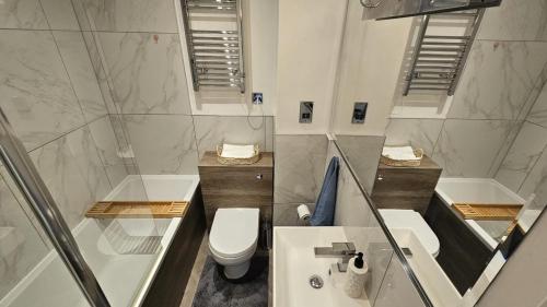 a bathroom with a toilet and a sink at The Windsor Lodge in Brighton & Hove