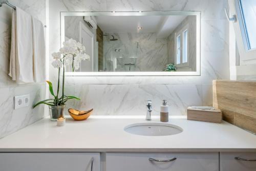 Baño blanco con lavabo y espejo en Familientraum in Strandnähe en Colares