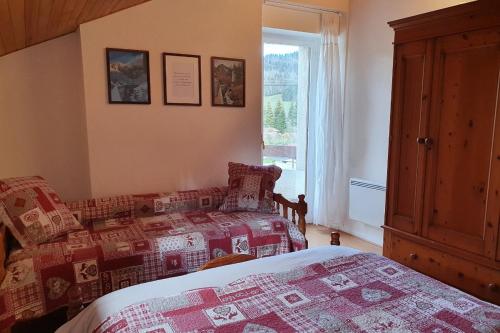 1 Schlafzimmer mit 2 Betten und einem Fenster in der Unterkunft Le Logis de Pimpi in Lamoura