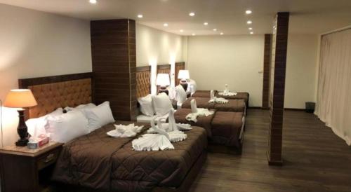 a hotel room with two beds with swans on them at Great Pyramid Inn in Cairo