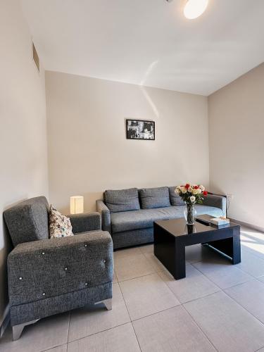 a living room with a couch and a coffee table at Celino Hotel in Amman