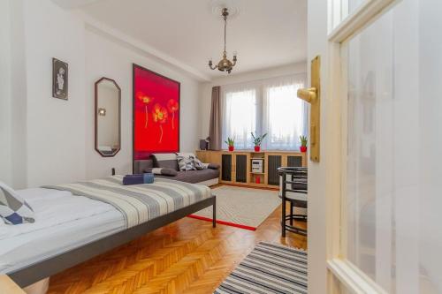 a bedroom with a bed and a desk in it at Poppy's Home by the Danube by NW in Budapest