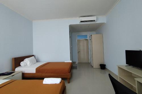 Hotel Sutha Inn Syariahにあるテレビまたはエンターテインメントセンター
