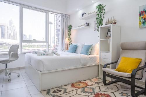 a bedroom with a bed and a chair and a window at Cozy Haven with Spiritual Charm in JLT in Dubai