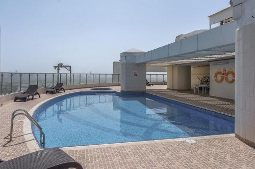 a large swimming pool on top of a building at Cozy Haven with Spiritual Charm in JLT in Dubai