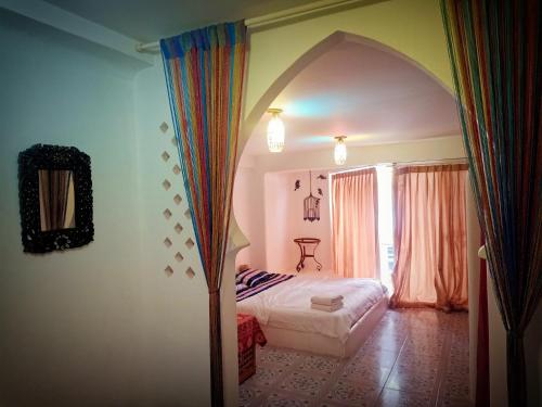 a bedroom with a bed and a window at The Casa Blanca Room condo in Hua Hin