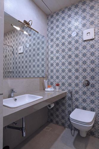 a bathroom with a sink and a toilet at juSTa Rudra Resort & Spa in Kolād