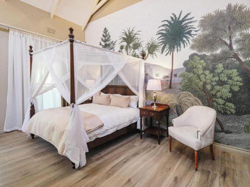a bedroom with a canopy bed and a chair at The Peech Boutique Hotel Zimbabwe in Kingsmead