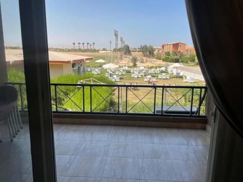 a room with a balcony with a view of a field at شالية مارينا وادى دجلة in Ain Sokhna