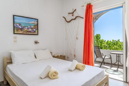 a bedroom with a bed and a balcony with a table at 6 Kypri Seaview Perasma Studio in Kypri
