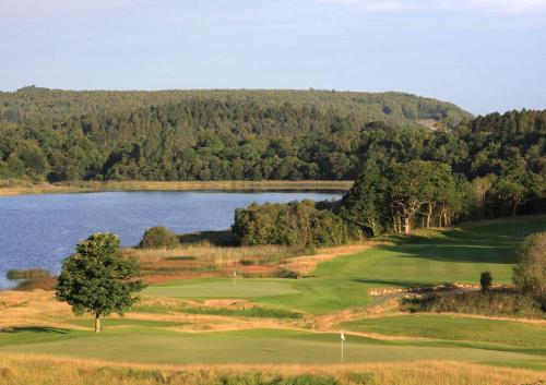 a view of a golf course with a lake at Escape Ordinary at Castle Hume in Enniskillen