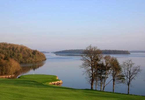 a golf course with a view of a lake at Escape Ordinary at Castle Hume in Enniskillen