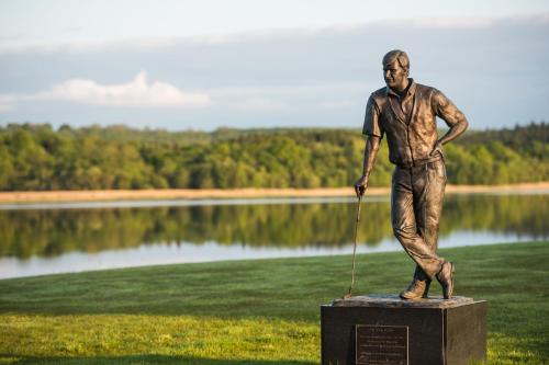 a statue of a man with a rope in front of a lake at Escape Ordinary at Castle Hume in Enniskillen