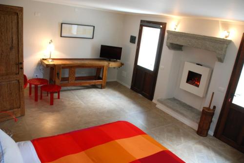 uma sala de estar com uma mesa e uma lareira em Ca' del Borgo em Cadarese