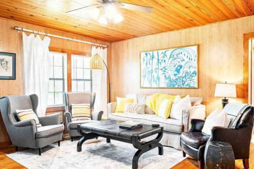 a living room with a couch and chairs and a table at Humble Bee Cottage-Cullman in Hanceville