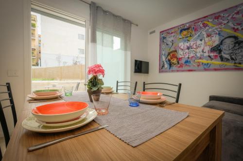 a dining room table with bowls and plates on it at BergamoCityCenter 01 in Bergamo