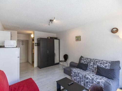 a living room with a couch and a refrigerator at Studio 3 pers au cœur de la station de Gourette - FR-1-400-12 in Gourette