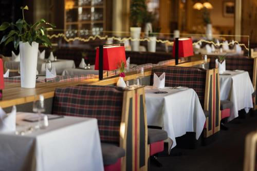a row of tables and chairs in a restaurant at Hotel Franks in Oberstdorf