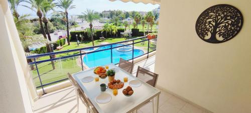 a white table with food on top of a balcony at Apartamento Sueño de Denia II by DENIA COSTA in Denia