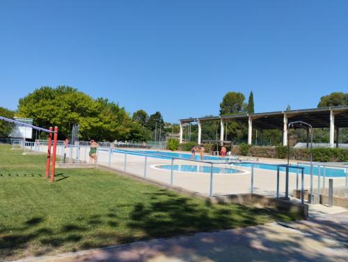 a large swimming pool with people in it at Apartamentos Canana de Vega in Flix