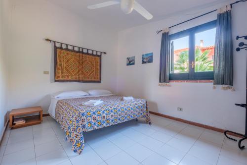 a bedroom with a bed and a large window at Jera suite vista mare 2 in Vulcano