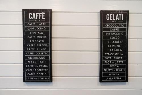 a couple of black signs on the side of a wall at Schwarzwaldtraum in Sasbachwalden