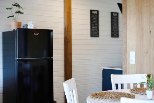 a kitchen with a black refrigerator and a table at Schwarzwaldtraum in Sasbachwalden