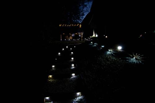 a row of candles on the ground at night at ARK-LAK 