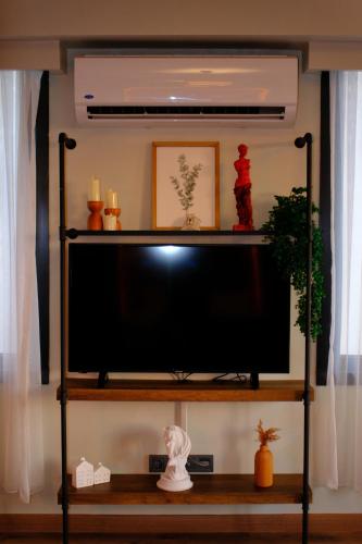 a flat screen tv on a shelf in a room at Karaköy in Karaköy Hotel in Istanbul