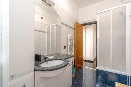 a bathroom with a sink and a shower at Castelletto Roomy & Functional Flat in Genova