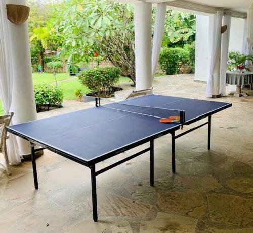 a ping pong table sitting on top of a court at WHITE Nyumba in Malindi