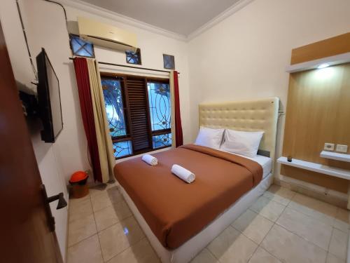 Postel nebo postele na pokoji v ubytování House of Scorpio Timoho
