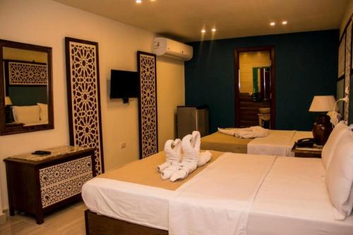 a hotel room with two beds with towels on them at Great Pyramid Inn in Cairo