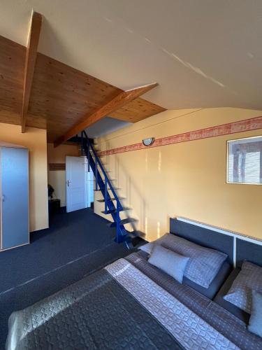 a living room with a couch and a staircase at Penzion Ariane in Prague