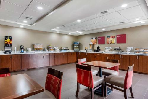 a restaurant with a table and chairs and a counter at Comfort Suites Lafayette University Area in Lafayette